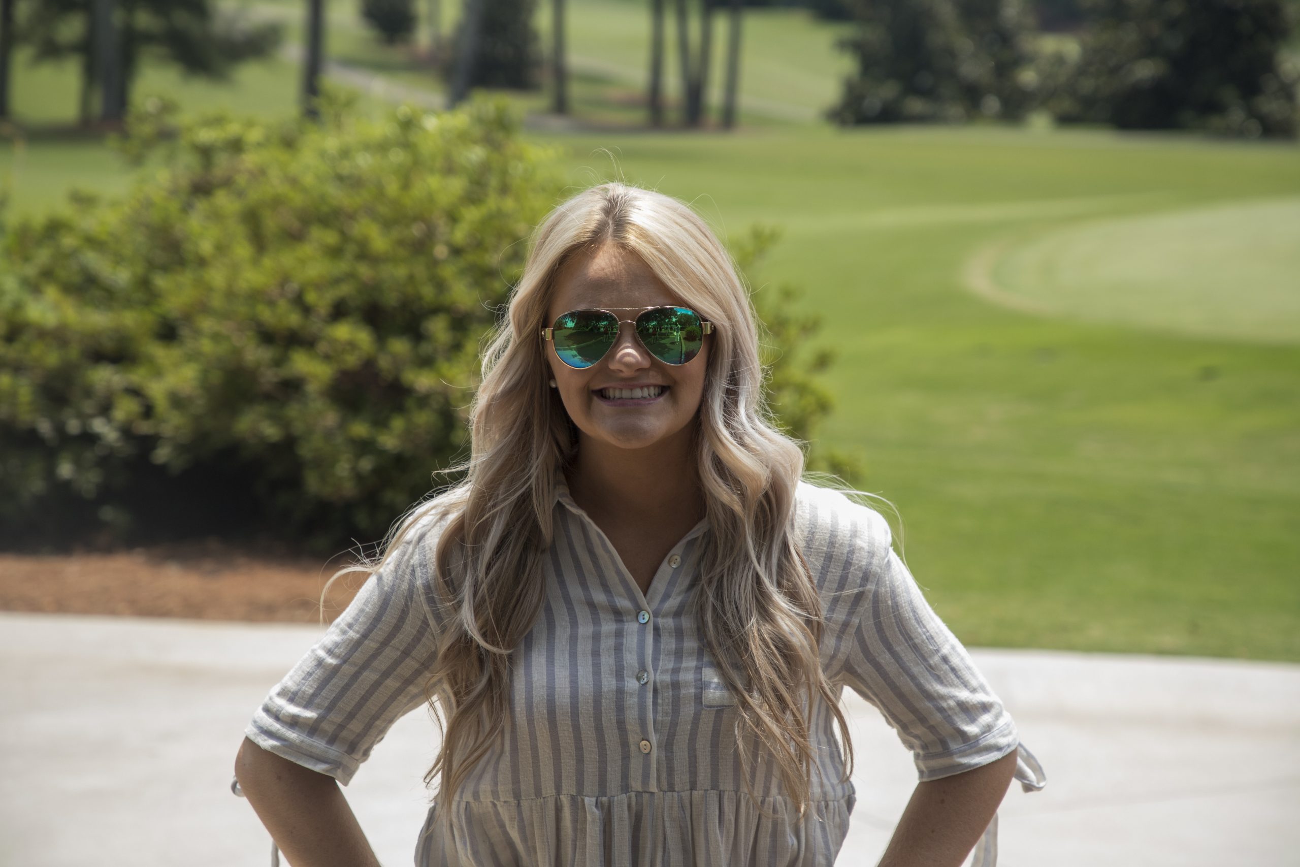 Woman with Golf Course behind her.